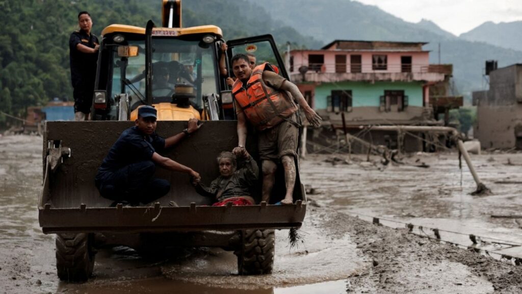 A survivor is transported to a safer place in a JCB following a flash flood at Trishuli in Nuwakot district, Nepal, August 26, 2026. REUTERS/Navesh Chitrakar