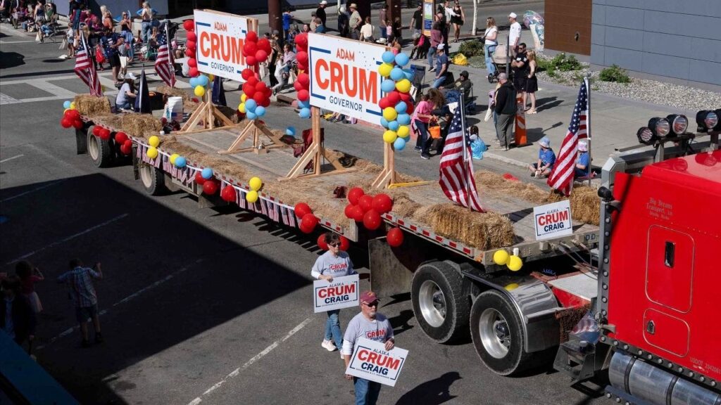 A truck with posters of Republican Adam Crum, one of the 17 candidates running for governor in Alaska, participates in the Golden Days parade in Fairbanks, Alaska, July 25, 2026. Crum has taken to “guerrilla campaigning,” skipping traditional political events like parades to serve hot chocolate to snowmobilers in the woods. (Ruth Fremson/The New York Times)