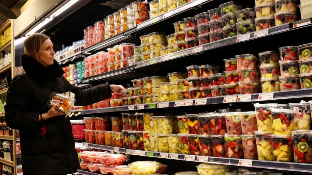 A woman shops for fruit in a store in New York City, U.S., February 12, 2025. REUTERS/Brendan McDermid