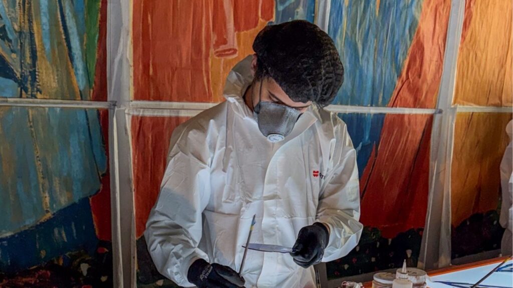 An artisan working at the Atelier Simon-Marq, a centuries-old stained glass studio, in Reims, in northeastern France, July 23, 2026. Seven and a half years after a raging fire nearly destroyed the Notre-Dame Cathedral in Paris, workers will soon begin installing the most contentious feature of its meticulous restoration: six towering stained-glass windows that depict the Christian feast of Pentecost. (Mark Landler/The New York Times)