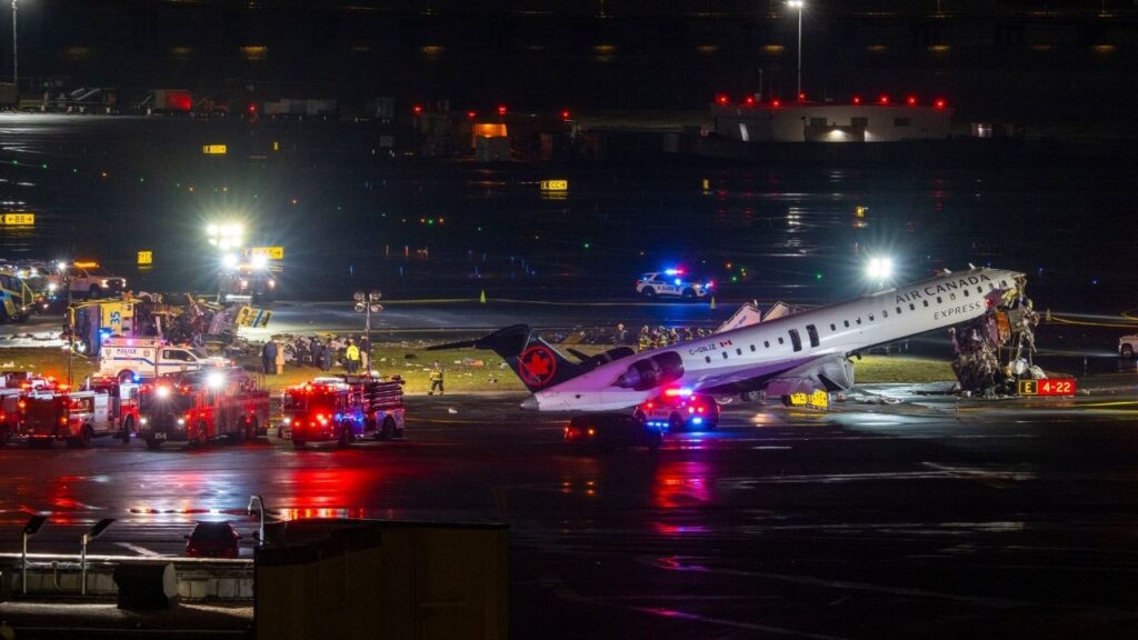 An Air Canada Express jet sits wrecked after a collision with a fire truck at LaGuardia Airport in Queens on March 23, 2026. Two air traffic controllers stepped away early from their posts at the airport, leaving the tower short-staffed before the collision that killed two people, according to two people familiar with the matter. (Dakota Santiago/The New York Times)