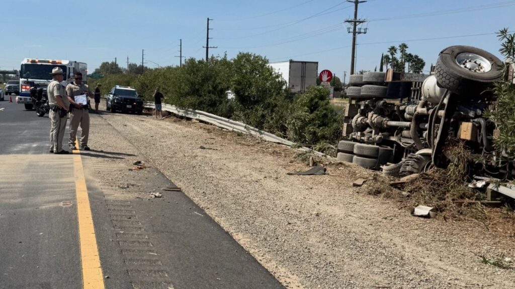 An overturned big rig closed a southbound Highway 99 lane at Franklin Road near Atwater as crews work to remove the truck and repair a damaged guardrail. (CHP)