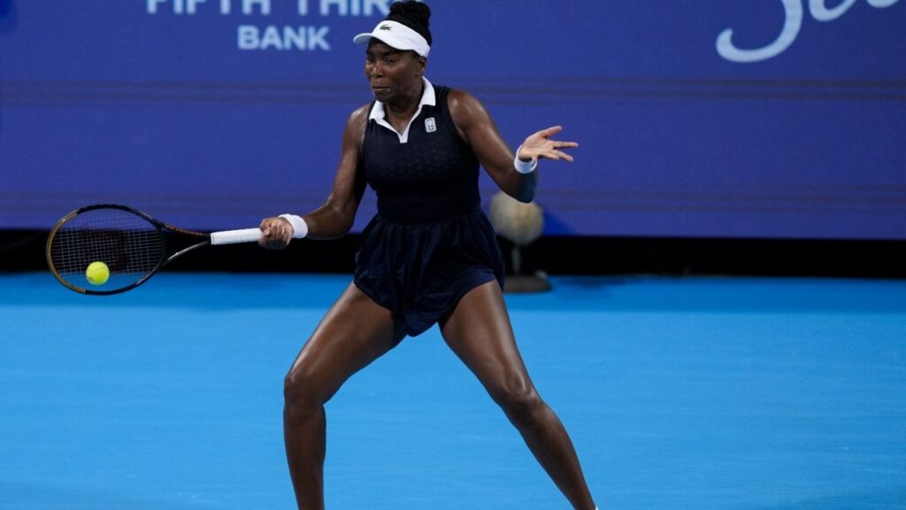 Aug 17, 2026; Mason, OH, USA; Venus Williams of the United States returns a shot against Marta Kostyuk of Ukraine and Peyton Stearns of the United States in their doubles match during the Cincinnati Open at Lindner Family Tennis Center. Mandatory Credit: Aaron Doster-Imagn Images