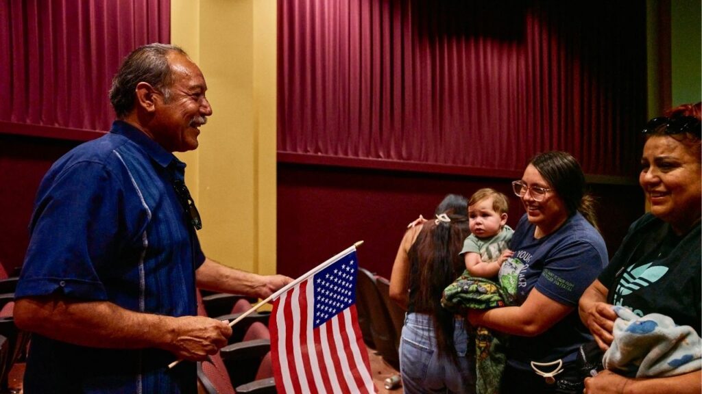 Avenal Mayor Alvaro Preciado, left, celebrates with residents after watching the FIFA World Cup Mexico vs. Ecuador match at the Avenal Theater and Event Center in Avenal, Calif., June 30, 2026. Avenal, Calif., a rural city in the Central Valley, has become an unlikely example of election denialism months after a recall election. (Philip Cheung/The New York Times)