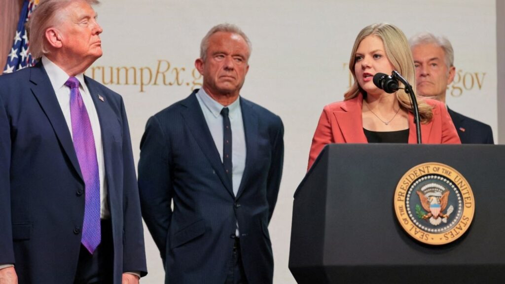 Centre for Medicare & Medicaid Services Administrator Dr Mehmet Oz, U.S. Health and Human Services Secretary Robert F. Kennedy Jr., and U.S. President Donald Trump stand as Heidi Overton speaks during an event to deliver remarks about health care costs and affordability from an auditorium on the White House campus in Washington, D.C., U.S., May 18, 2026. (Reuters File)