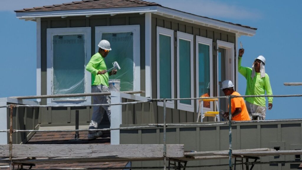 Construction workers paint a residential housing project during a heat wave, in Carlsbad, California, U.S. July 8, 2025. (Reuters/Mike Blake)
