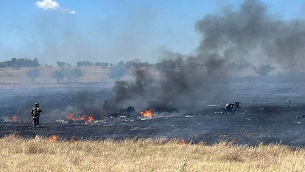 Emergency personnel respond to the crash of an AH-64 Apache military helicopter, attached to the U.S. Army base of Fort Hood, near Salado, Texas, U.S. August 12, 2026. Picture taken with a mobile phone. Cliff Coleman/Bell County Sheriff's Office/Handout via REUTERS