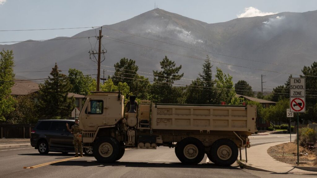A road is blocked off as the Hawk fire burns in Reno, Nev., on Monday, Aug. 24, 2026. The Hawk fire has burned more than 15,000 acres since it began on Saturday in the foothills of the Sierra Nevada near Reno. (Ian C. Bates/The New York Times)
