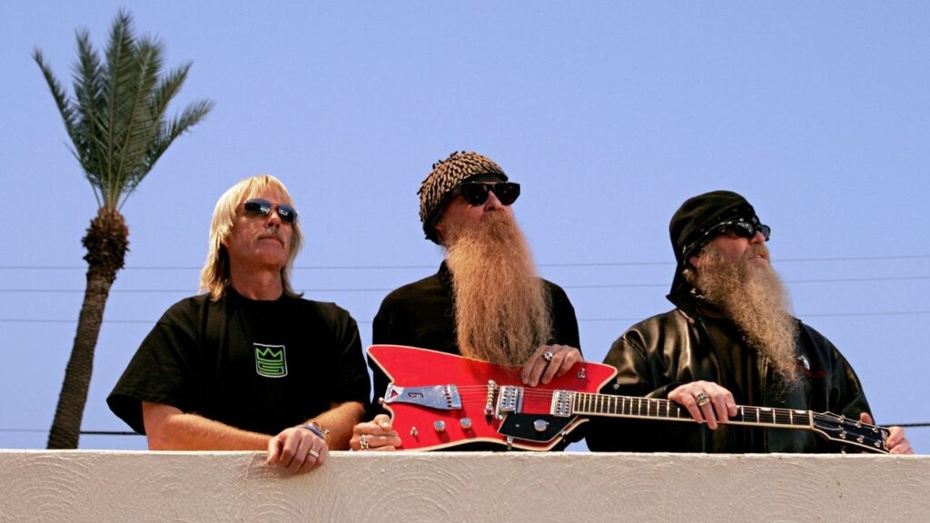 From left: Frank Beard, Billy Gibbons and Dusty Hill of ZZ Top before performing at the Arizona State Fair in Phoenix, Ariz., Nov. 4, 2005. Beard, whose drumming propelled the music of the hit-making Texas power trio ZZ Top for more than a half-century, died on Tuesday, Aug. 18, 2026. He was 77. (Jeff Topping/The New York Times)