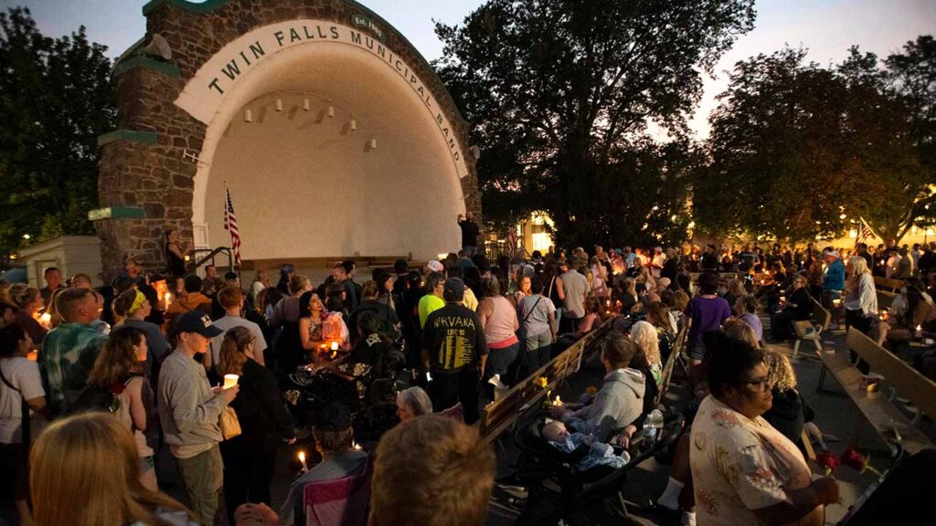 People gather at Twin Falls City Park in Twin Falls, Idaho, on Aug. 4, 2026, for a candlelight vigil for the victims of a shooting at an In-N-Out Burger restaurant. A complex mix of emotions has gripped Twin Falls in the days since a 24-year-old man with a rifle killed three people and wounded seven more at a brand-new In-N-Out. (Alex Hecht/The New York Times)
