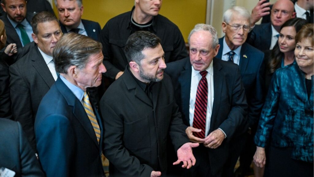 President Volodymyr Zelenskyy of Ukraine, center, speaks to reporters after a meeting with senators ahead of a vote on a bill that would impose new sanctions on Russia at the Capitol in Washington, on Tuesday, July 28, 2026. Ukraine and its supporters have invested years in trying to undo the skepticism of the country’s war effort harbored by President Donald Trump’s MAGA movement and the president himself. (Kenny Holston/The New York Times)