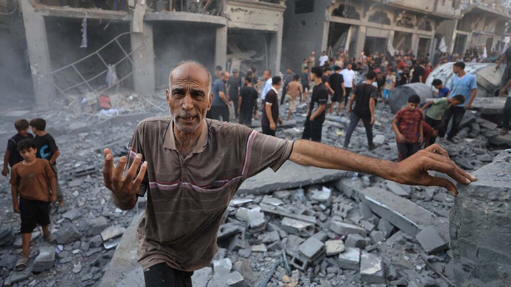 A man gestures as Palestinians inspect the site of an Israeli strike on a house, carried out after the Israeli military warned residents to evacuate the area, at al-Shati (Beach) refugee camp, in Gaza City, August 24, 2026. (Reuters/Dawoud Abu Alkas)