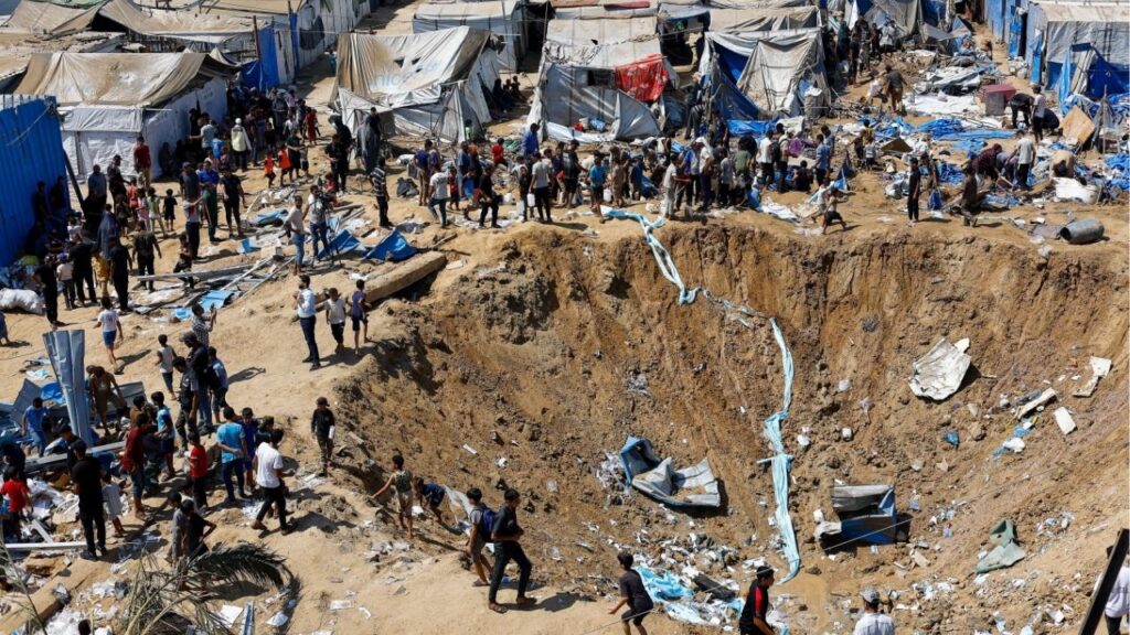 Palestinians inspect the site of an overnight Israeli strike on a medicine warehouse, according to medics, next to tents sheltering displaced Palestinians, in Deir al-Balah, in the central Gaza Strip, August 1, 2026, residents had been pre-warned by the Israeli military to evacuate. Reuters/Mahmoud Issa