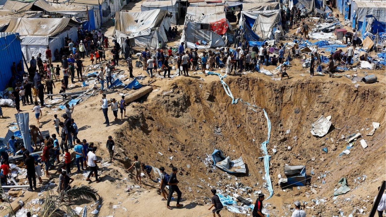 Palestinians inspect the site of an overnight Israeli strike on a medicine warehouse, according to medics, next to tents sheltering displaced Palestinians, in Deir al-Balah, in the central Gaza Strip, August 1, 2026, residents had been pre-warned by the Israeli military to evacuate. Reuters/Mahmoud Issa