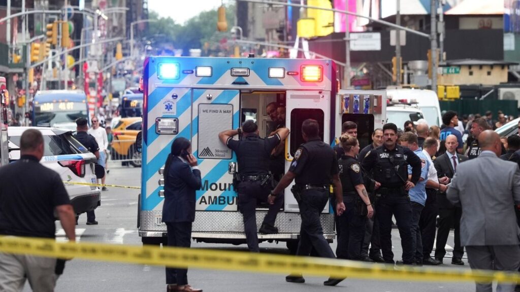 NYPD officers stand next to an ambulance at a stabbing scene in Times Square in Manhattan on Monday, Aug. 31, 2026. A woman stabbed at least two people in Times Square on Monday afternoon, one fatally, and was shot dead by the police after she refused to put down her knife, according to two people with knowledge of the episode. (Todd Heisler/The New York Times)