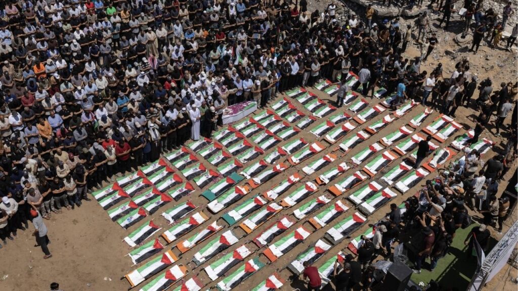 Palestinians attend the funeral of 112 members of the Hassayna and Abu Sharia clan, who were killed in an Israeli strike in 2023 and whose remains were recovered from beneath the rubble, according to Gaza's Civil Defense, in Gaza City, Aug. 4, 2026. (Saher Alghorra/The New York Times)