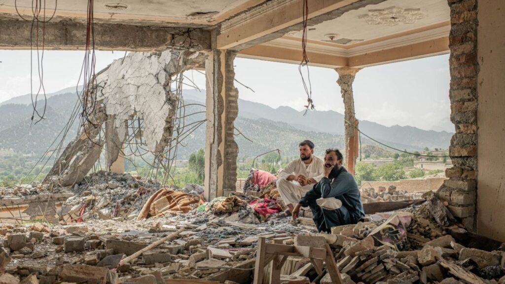 People at the remains of a house that was targeted during Pakistani airstrikes in June, at Mandakhel village, Paktia Province near the border with Pakistan, in Afghanistan, on Aug. 9, 2026. The Taliban may be boisterous in Kabul and have a tight grip on power, yet elsewhere they find themselves targeted and face crises both at home and abroad. (Tomas Munita/The New York Times)