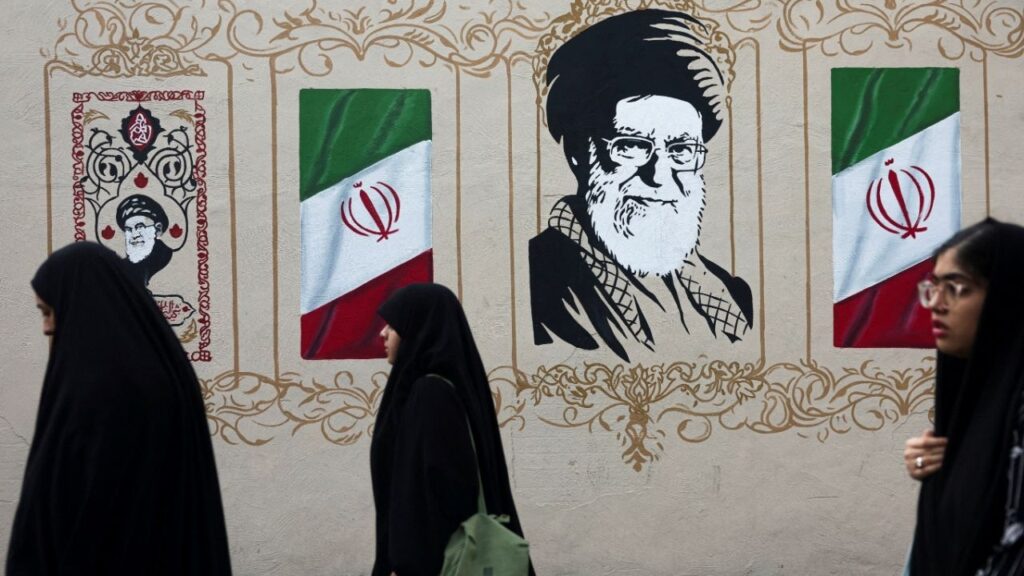 People walk by a mural depicting Iran's late Supreme Leader Ayatollah Ali Khamenei, on a street in Tehran, Iran, August 13, 2026. (Reuters File)