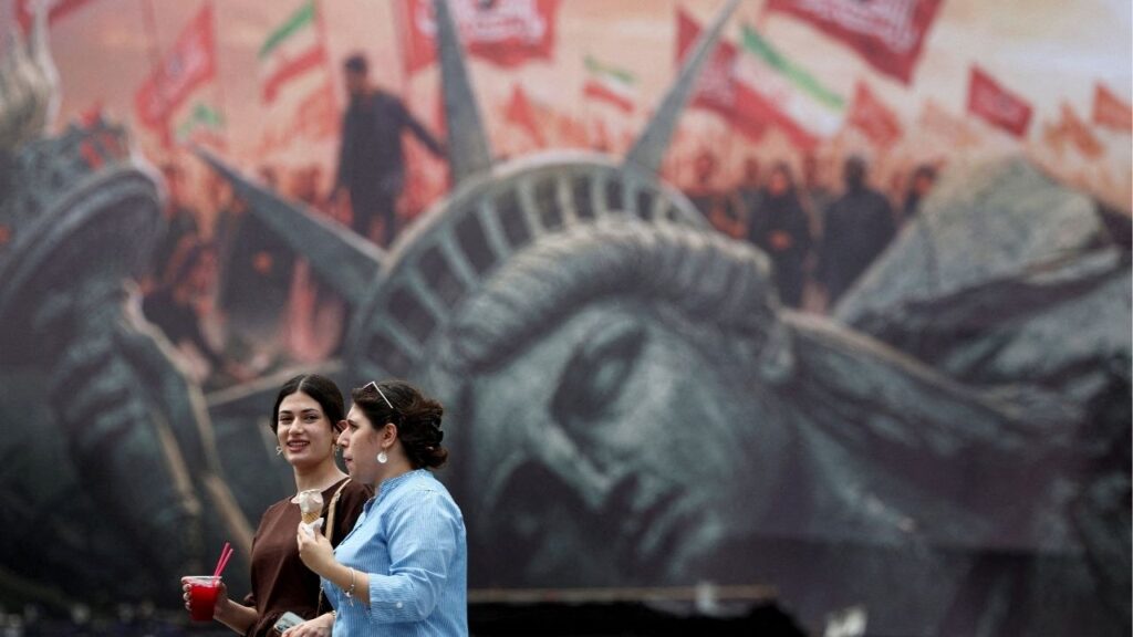 People walk past an anti-U.S. billboard on a street in Tehran, Iran, August 3, 2026. Majid Asgaripour/WANA (West Asia News Agency) via Reuters