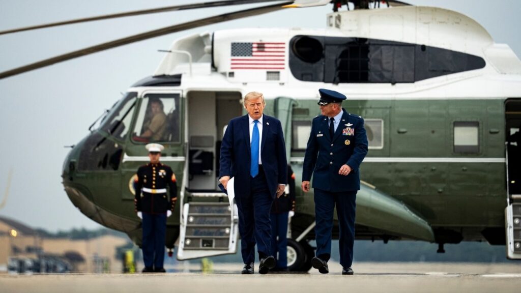President Donald Trump walks with Air Force Col. Christopher Robinson, commander of the 89th Airlift Wing, at Joint Base Andrews, Md., on Aug. 14, 2026. Trump issued his latest threat in the war with Iran, vowing on Wednesday, Aug. 19, 2026, to impose “tremendous economic consequences” on countries that do business with Iran. He did not specify in his social media post what actions he would take. (Al Drago/The New York Times)