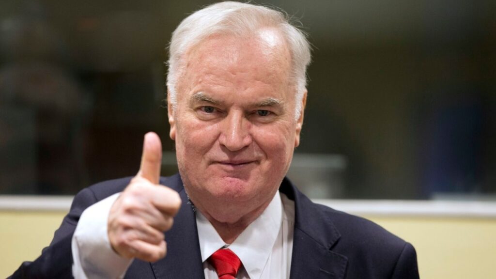 Ratko Mladic, the former Bosnian Serb general dubbed the “Butcher of Bosnia” for his actions during the Balkan wars of the 1990s, enters a courtroom in The Hague on Nov. 22, 2017, to hear the verdict from a United Nations war crimes tribunal. Mladic, who was captured in 2011 and convicted here of responsibility for the killing of some 8,000 Muslim men and boys at Srebrenica, has died, Serbian state media announced on Aug. 27, 2026. He was 83. (Peter Dejong/Pool via The New York Times)