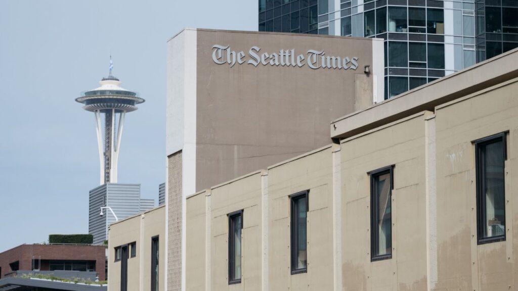 Image of the Seattle Times building with the Space Needle in the background