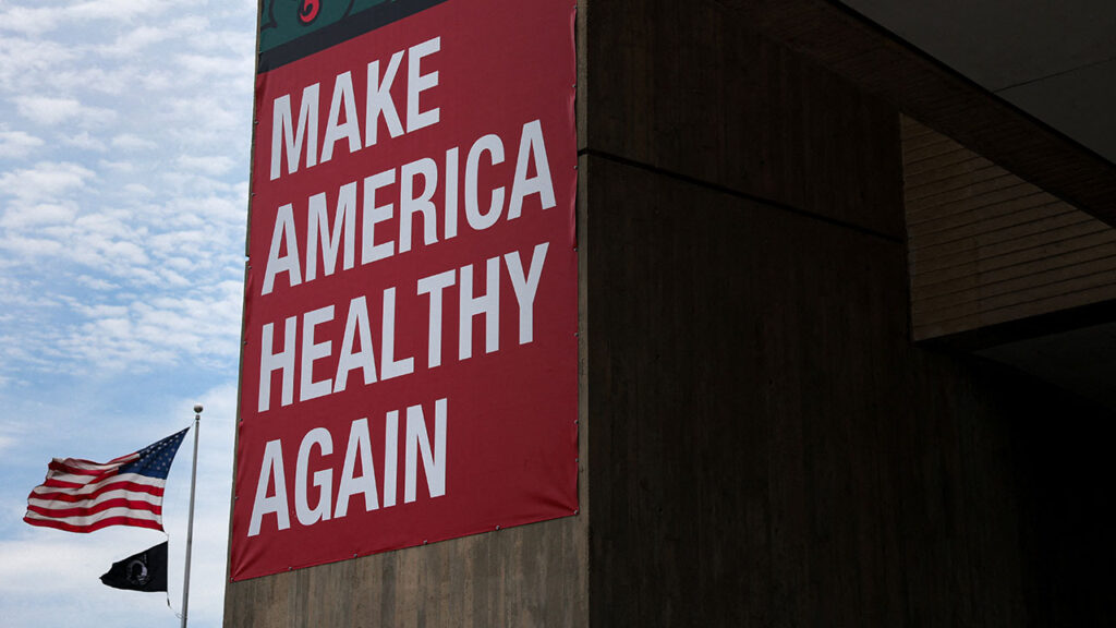 An American flag flies near a "Make America Healthy Again" banner hung on the Humphrey Building, where the U.S. Department of Health and Human Services office is located, in Washington, D.C., U.S., July 21, 2026. (Reuters/Kylie Cooper)