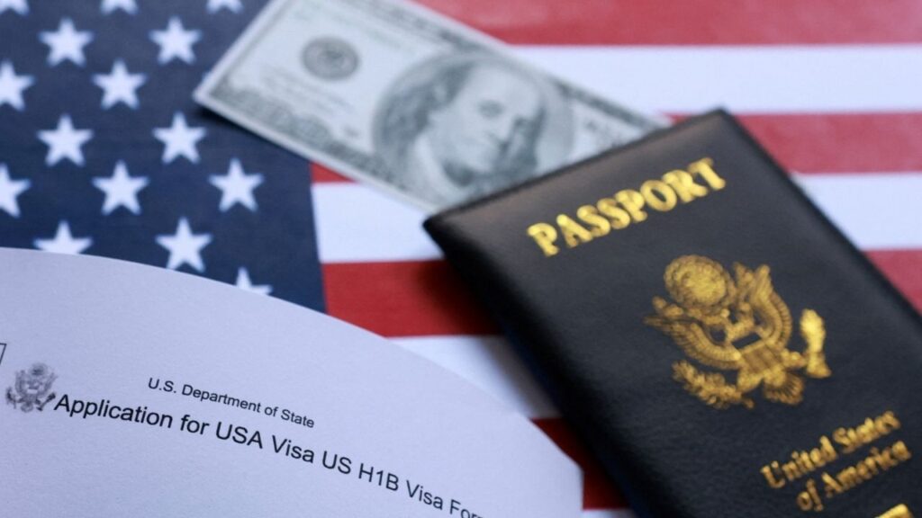 U.S. flag, mock passport and dollar banknote, and H-1B visa application form are seen in this illustration taken September 26, 2025. REUTERS/Dado Ruvic/Illustration