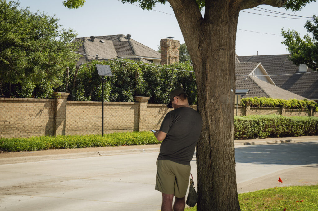Philip, a cellphone tower repairman, logs a Flock Safety automated license plate-reading camera in Addison, Texas, Aug. 2, 2026. In Texas, there’s one thing liberals and conservatives agree on: They don’t want cameras trained on their cars. (Desiree Rios/The New York Times)