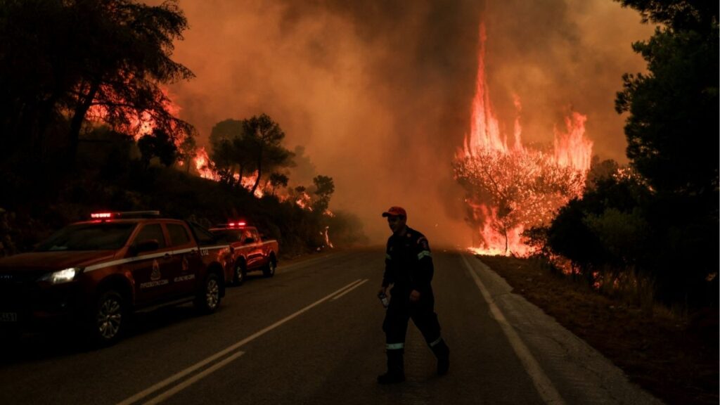 A firefighter walks away as a tree burns in the background during a wildfire near Agia Paraskevi, Greece, August 1, 2026. Reuters/Louisa Gouliamaki