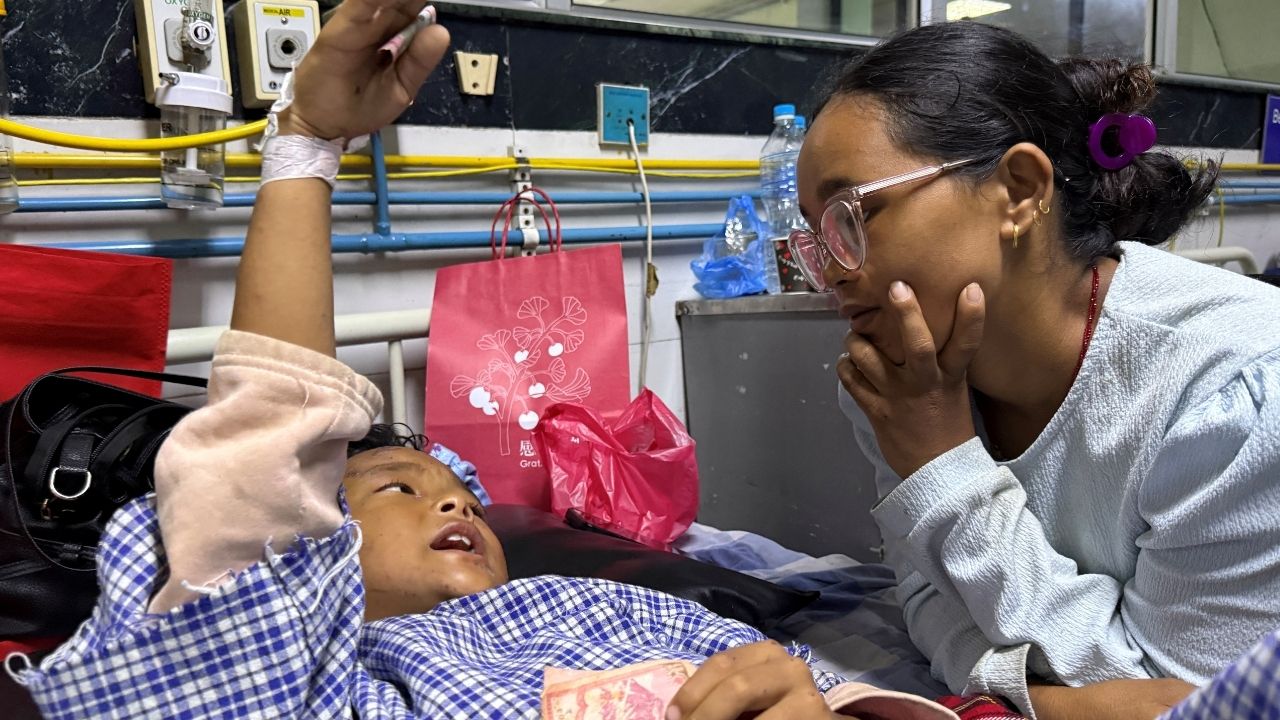 Zoyal Ghale, 8, who was airlifted from Rasuwa after being injured in the deadly flash floods and mudslide, speaks with his mother Matti Maya Tamang, 28, two days after they were separated following the floods, inside a hospital in Kathmandu, Nepal, August 28, 2026. Picture taken with a mobile phone. REUTERS/Ranup Shrestha
