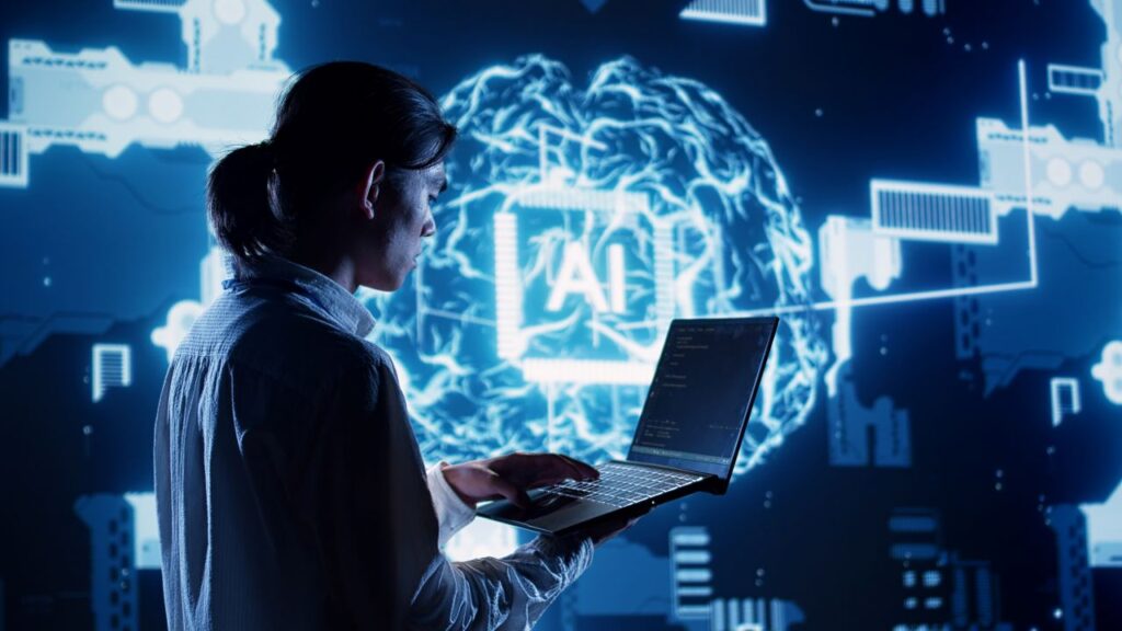 Composite image of a woman in an AI data center operating a laptop. The scene is cast in a blue hue.