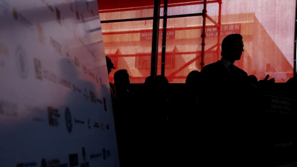 Silhouette of Gov. Gavin Newsom facing right against a multicolored background