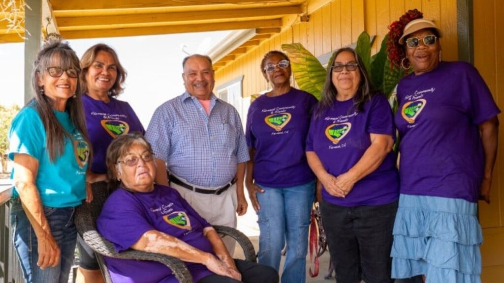 Image of Fairmead homeowners, most of whom are wearing purple t-shirts