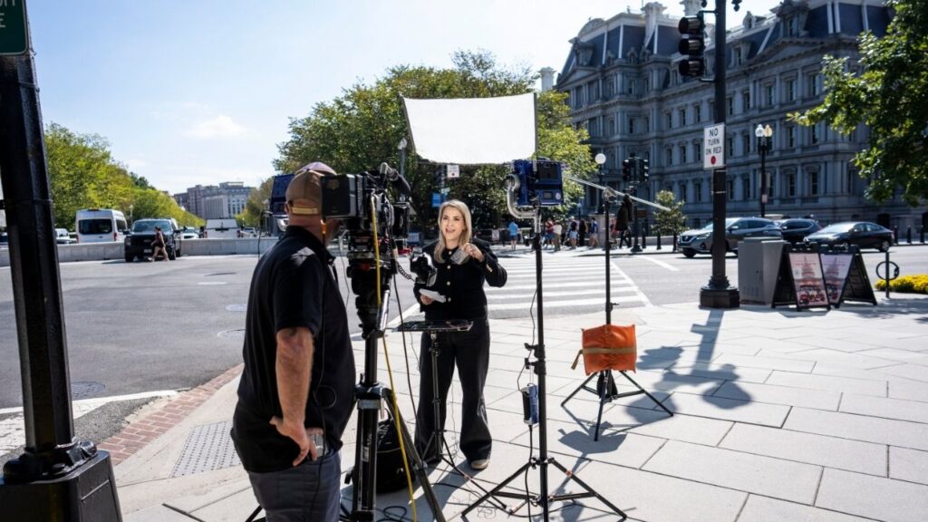 A CNN reporter holds her empty credential holder while speaking on camera outside the White House grounds after the White House confiscated her badge on Saturday in Washington, Sept. 19, 2026. The Trump administration removed CNN from its duties as the pool representative for television networks on Monday, days after barring journalists from the outlet, MS NOW and Politico from the White House. (Doug Mills/The New York Times)