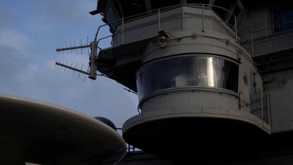 A U.S. Navy sailor stands watch on the island of the USS George Washington in the Arabian Sea, September 11, 2026. REUTERS/Ed Ou