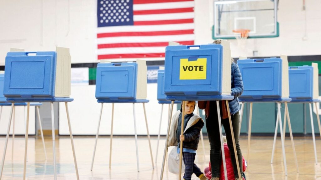 A boy peers out from under a voting booth as his mother marks her ballot during the state’s primary election to choose candidates for the November midterm elections, in Cary, North Carolina, U.S., March 3, 2026. (Reuters File)