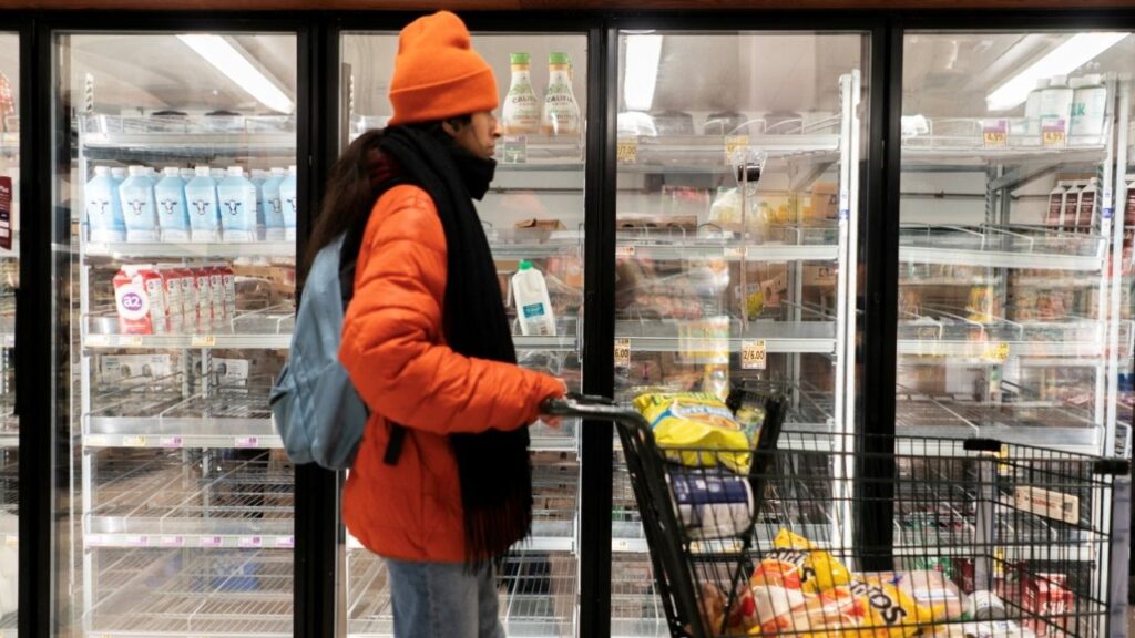 A shopper walks past a partially empty dairy section at a grocery store ahead of an expected winter storm spreading across the United States, in Washington, D.C., U.S., January 24, 2026. REUTERS/Nathan Howard