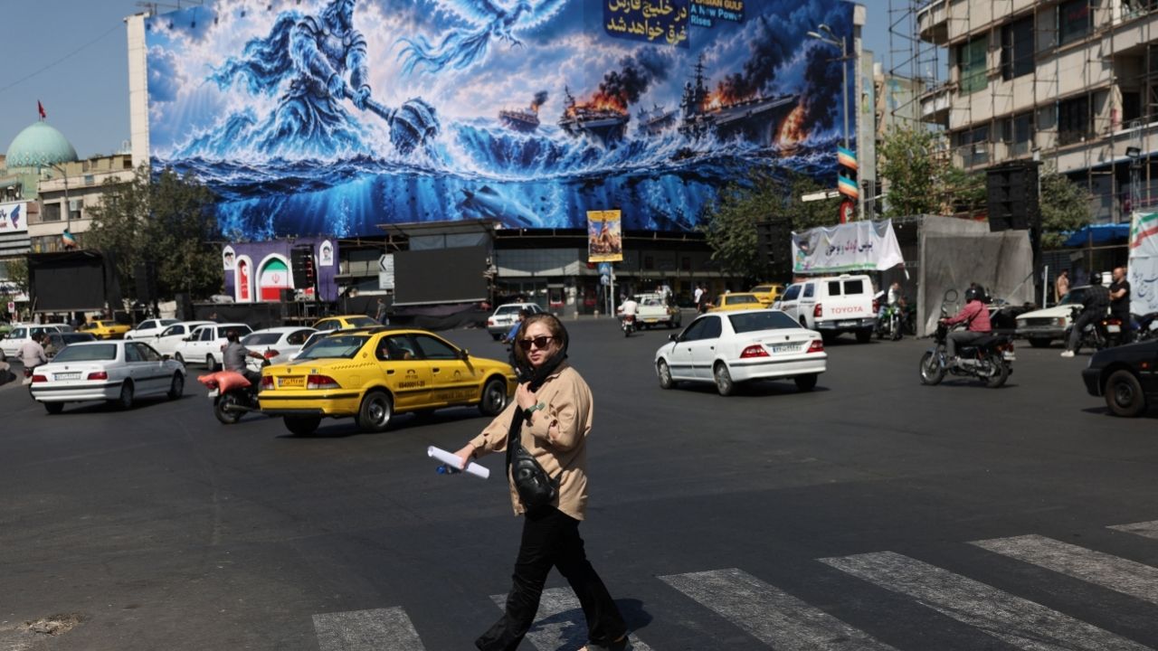 A woman walks past a billboard about the Strait of Hormuz, on a building in Tehran, Iran, September 16, 2026. Majid Asgaripour/WANA (West Asia News Agency) via REUTERS