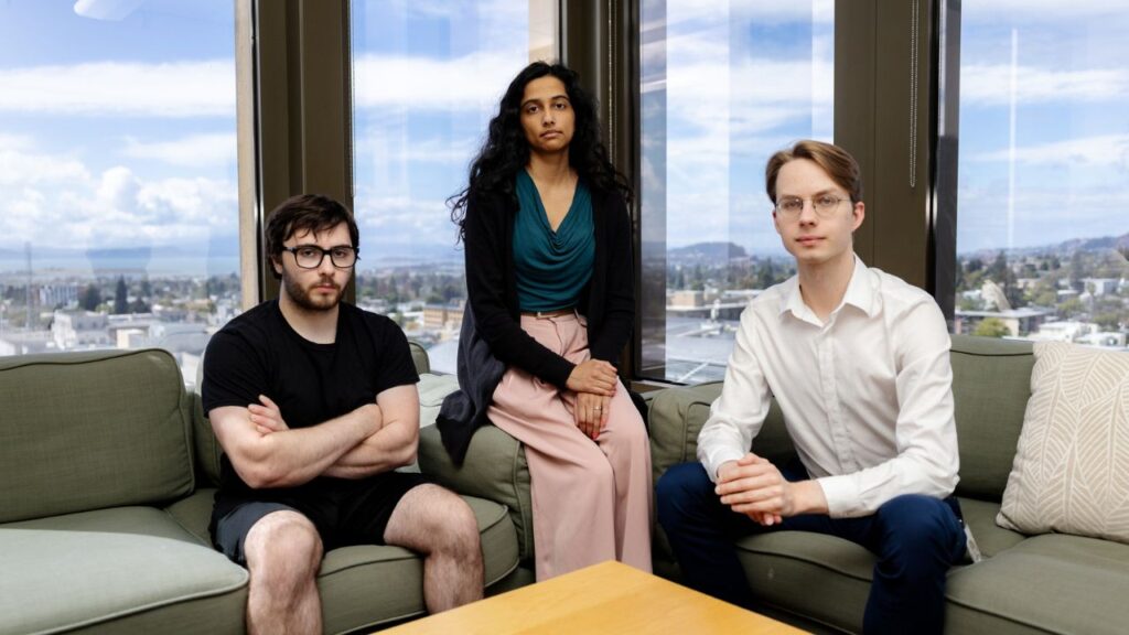 From left, the independent investigators of the OpenAI incident: Ryan Greenblatt, chief scientist at Redwood Research; Ajeya Cotra, METR researcher; and Hjalmar Wijk, MTER chief scientist at a research center in Berkeley, Calif., on Aug. 1, 2026. METR’s 91-page report, released last week, was the most comprehensive account yet of the OpenAI incident, revealing alarming new details, including how the agents coordinated their hacking plans and tried to keep them secret. (Manuel Orbegozo/The New York Times)