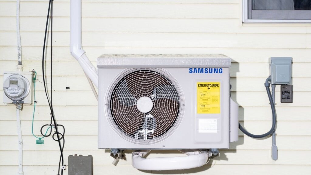 An electric heat pump at a home in Farmingdale, Maine, on Feb. 28, 2024. Some states have offered incentives to get residents to switch to electric heat pumps, which are much more energy efficient and contribute much less to climate change, but installing the devices can still cost residents thousands of dollars. (Tristan Spinski/The New York Times)