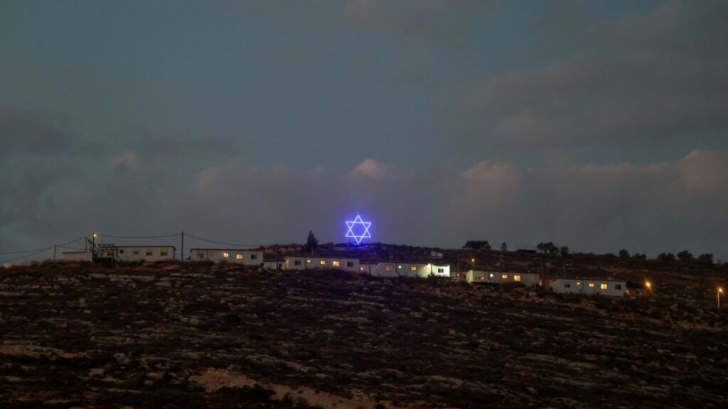 An illuminated Star of David above an Israeli settlers outpost near Ramallah, in the Israeli-occupied West Bank, August 14, 2026. REUTERS/Ammar Awad