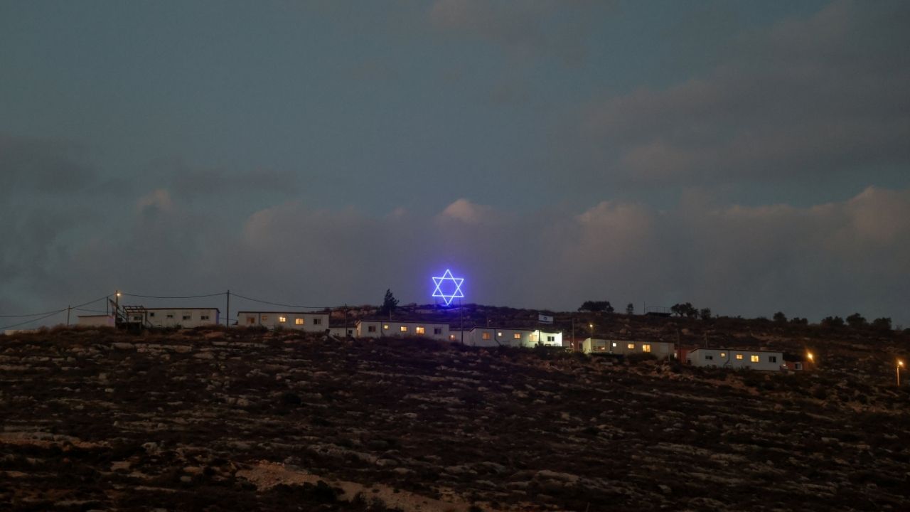 An illuminated Star of David above an Israeli settlers outpost near Ramallah, in the Israeli-occupied West Bank, August 14, 2026. REUTERS/Ammar Awad