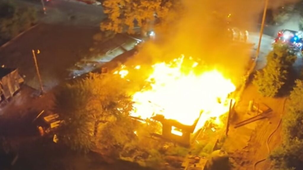 Firefighters battling a house fire east of Reedley Thursday night pulled back after encountering downed power lines. (CalFire)