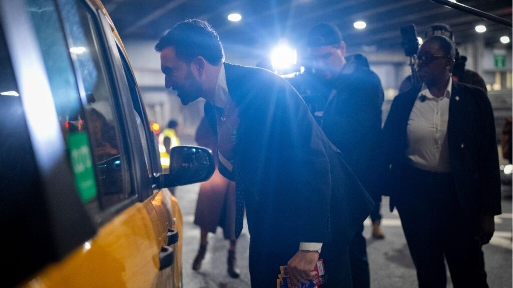Zohran Mamdani, the Democratic candidate for New York City mayor, greets taxi drivers while canvassing at LaGuardia Airport in New York, Oct. 30, 2025. Mamdani is seen as a social media wizard; some of his popularity stems from an influencer operation run by the mayor’s office. (Vincent Alban/The New York Times)
