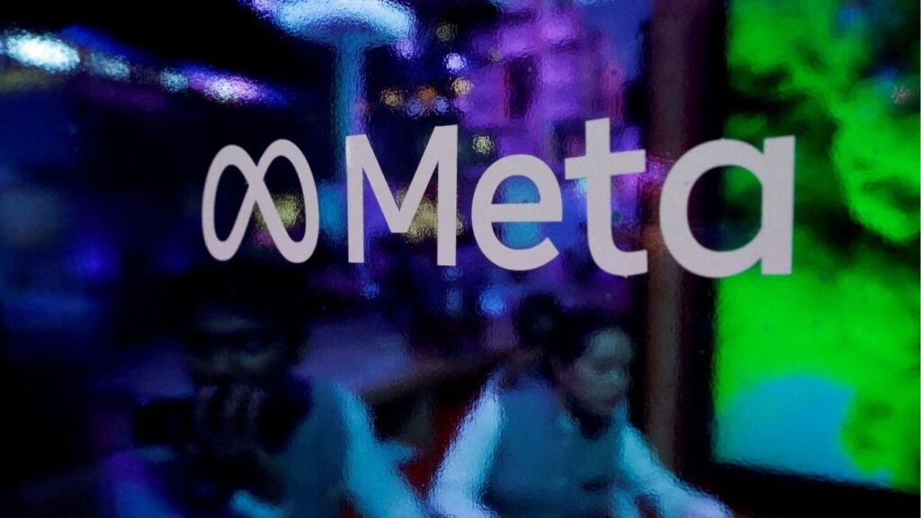 FILE PHOTO: People are seen behind a logo of Meta Platforms, during a conference in Mumbai, India, September 20, 2023. Reuters/Francis Mascarenhas/File Photo