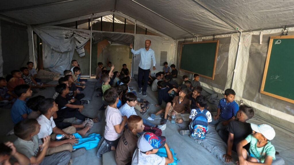 Palestinian students attend their first day of the new school year inside a tent classroom at a school in Khan Younis, in the southern Gaza Strip, September 19, 2026. REUTERS/Ramadan Abed