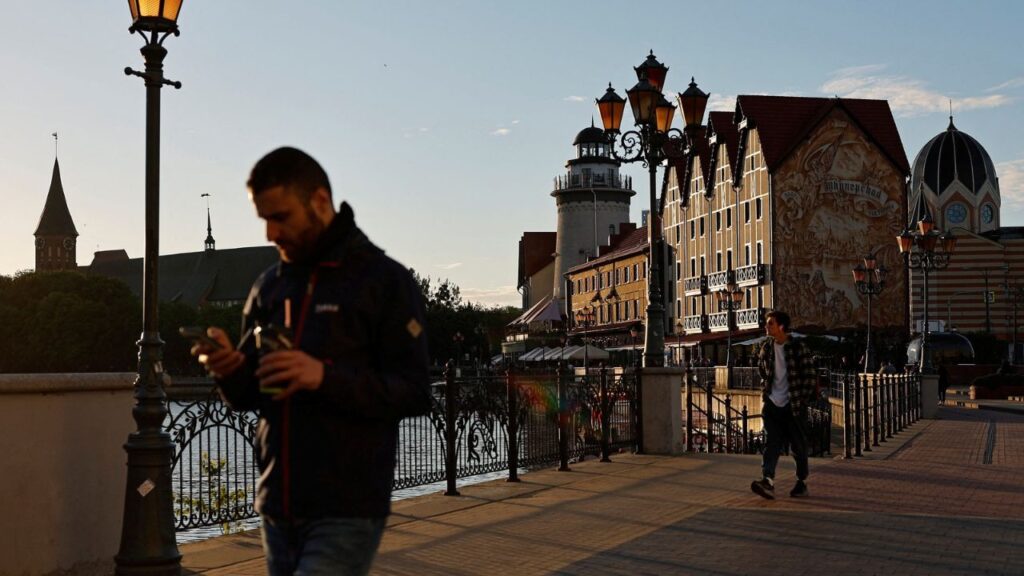 People walk along an embankment of the Pregolya River in Kaliningrad, Russia June 22, 2022. REUTERS/Vitaly Nevar