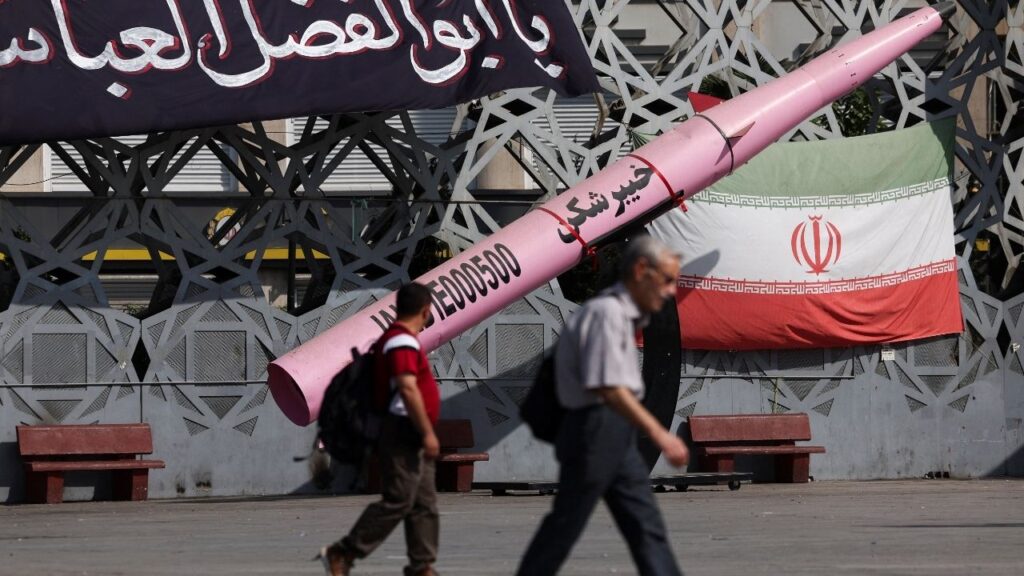 People walk next to a symbolic mockup of an Iranian missile and an Iranian flag at Imam Hussein Square in Tehran, Iran, July 12, 2026. Majid Asgaripour/WANA (West Asia News Agency) via REUTERS