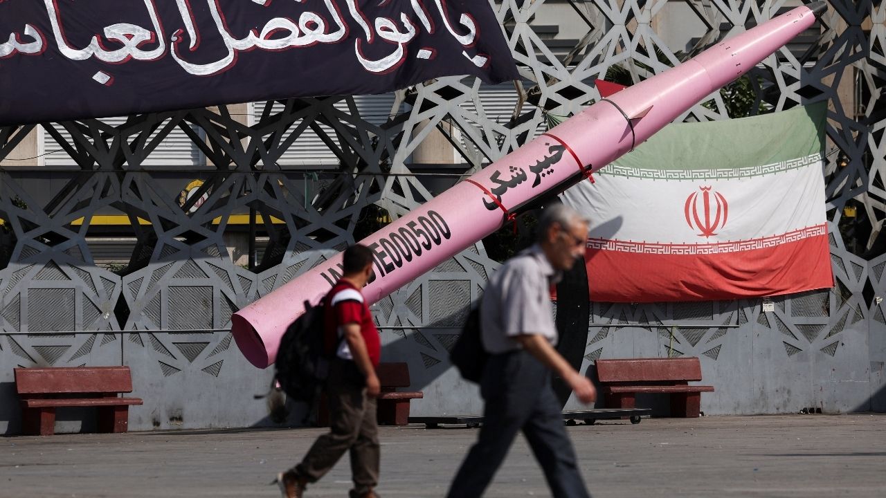 People walk next to a symbolic mockup of an Iranian missile and an Iranian flag at Imam Hussein Square in Tehran, Iran, July 12, 2026. Majid Asgaripour/WANA (West Asia News Agency) via REUTERS